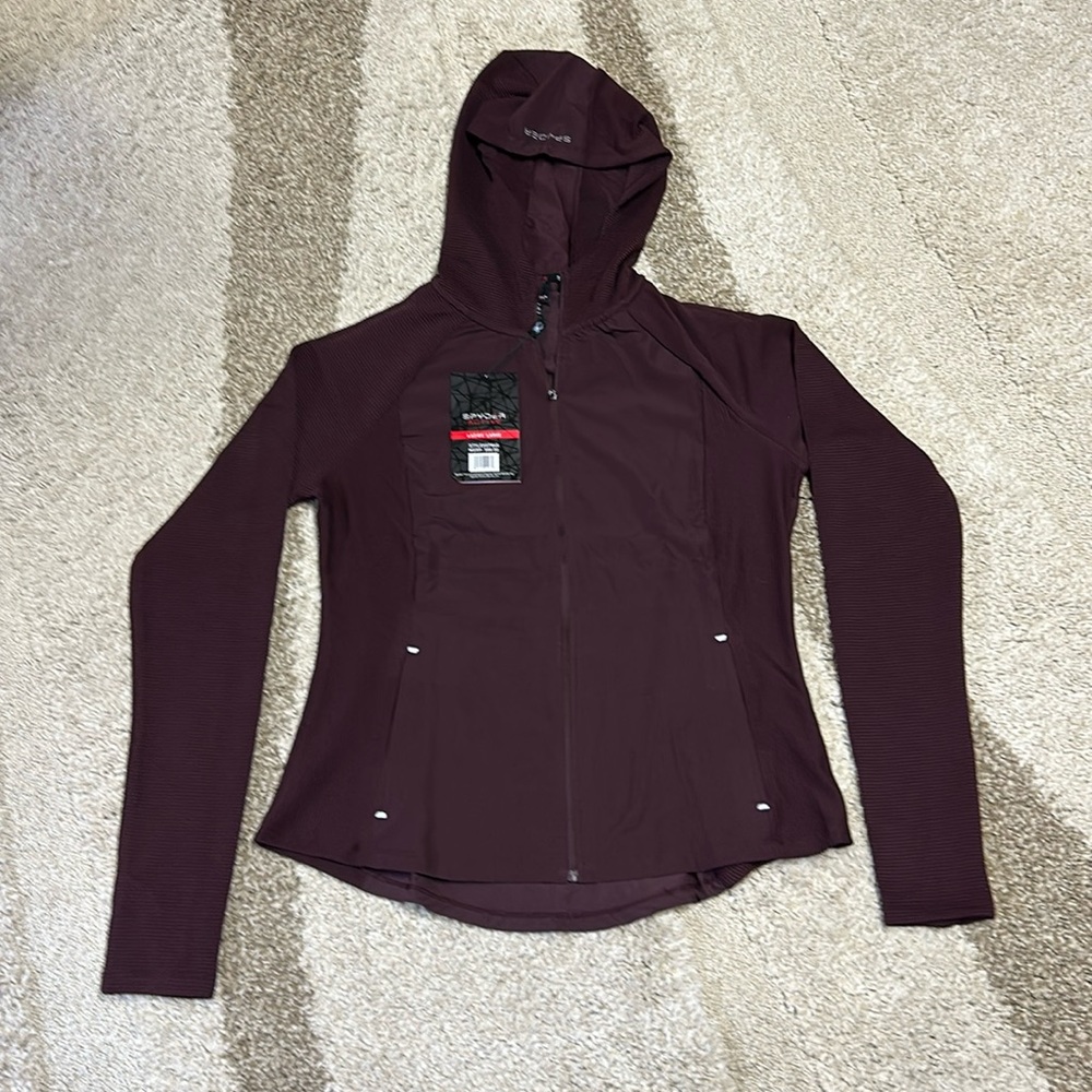 Spyder quick dry, full zip light coat. Zippered pockets. Thumb holes.